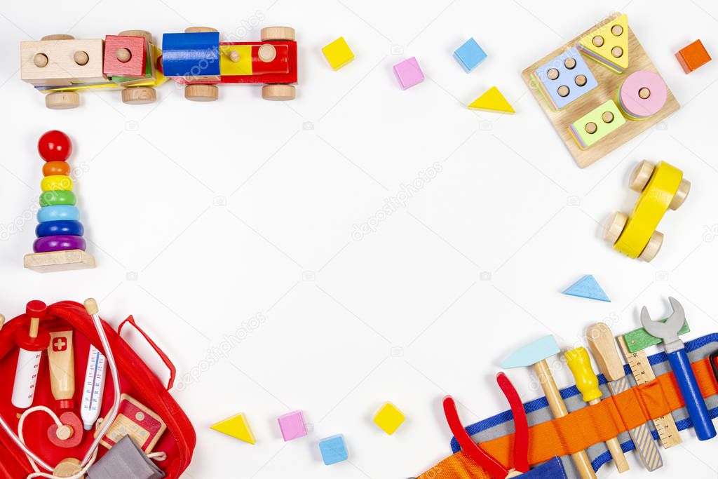 Baby kids toys background. Wooden educational toys, train, rainbow, airplane, blocks, construction tools and set of toy medical devices on white background