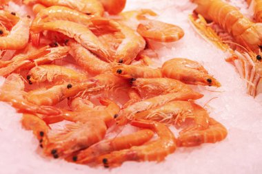 Top view to shrimps on display on ice in fisherman market store in Spanish market