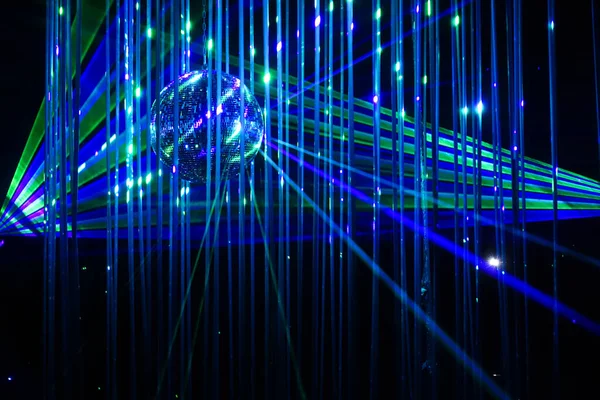 Green and blue laser beams on black background. Laser show rays stream at night time
