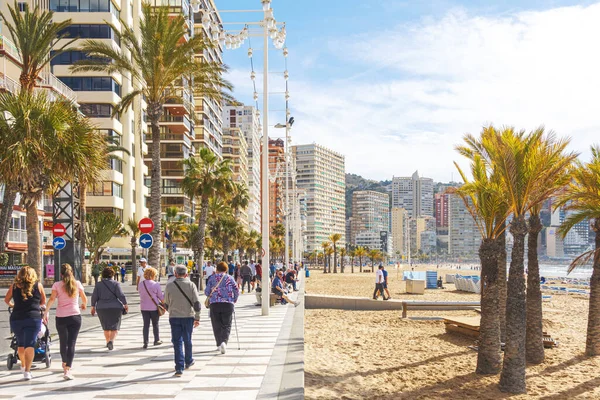 Benidorm, Spain - February 25, 2020: Winter in Benidorm. People relax in Levante area of popular spanish resort Benidorm, Alicante, Spain