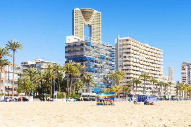 Benidorm, Spain - February 24, 2020: People relaxing at Benidorm city Poniente beach at sunny day