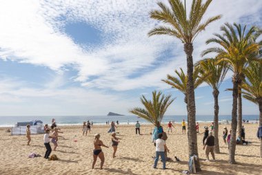Benidorm, Spain - February 25, 2020: Active senior people doing sport exercises on the beach. Healthy lifestyle, active lifestyle retiree in Benidorm, Spain