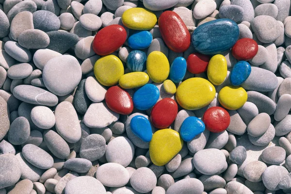 World autism awareness day. Top view to white beach stones with colorful heart made of painted stones — Stock Photo, Image