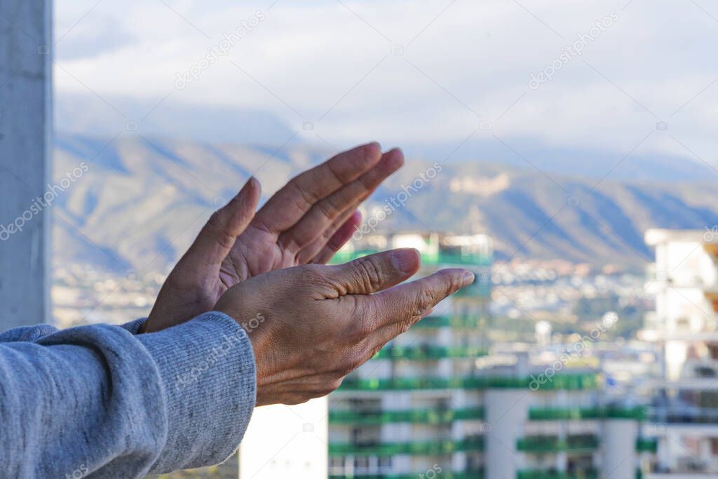 Woman hands applauding medical staff from their balcony. People in Spain clapping on balconies and windows in support of health workers, doctors and nurses during the Coronavirus pandemic