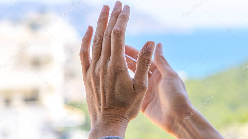 Woman hands applauding medical staff from their balcony. People in Spain clapping gratitude on balconies and windows in support of health workers, doctors and nurses during the Coronavirus pandemic