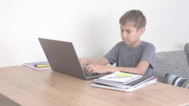 Dizüstü bilgisayarla çocuk öğrenme, evde ödev yapma. Annem ona yardım etmeye geldi. Teknoloji, uzaktan eğitim, evden online öğrenme