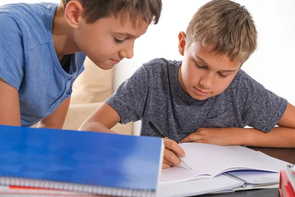 Learning at home, distance education, online learning. Children at home doing homework with books notebooks and thinking how to make math tasks — Stock Photo, Image