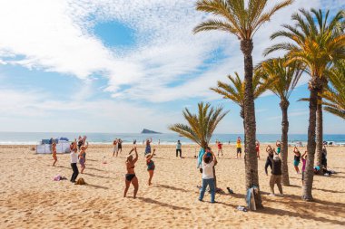 Benidorm, Spain - February 25, 2020: Active senior people doing sport exercises on the beach. Healthy lifestyle, active lifestyle retiree in Benidorm, Spain