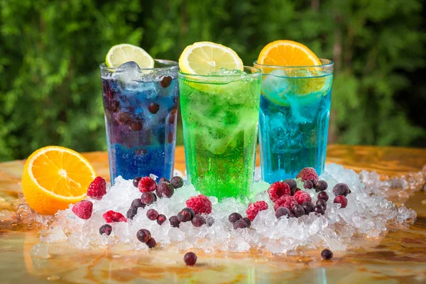 Summer cocktails in ice with berries — Stock Photo, Image