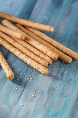 İtalyan ekmeği bir bardakta tuzlu bir masada.