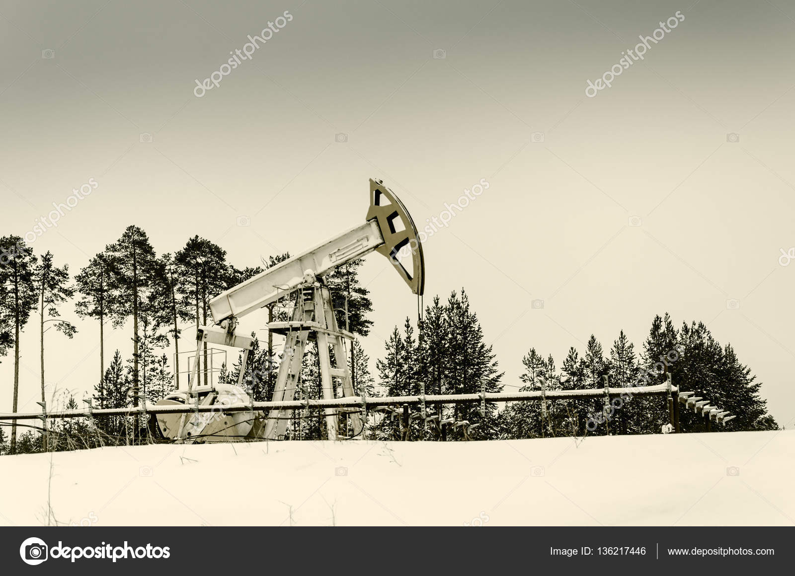 Pump jack and wellhead in the oilfield Stock Photo by ©PolinaPetrenko