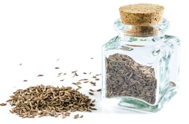 Kimyon tohumu cam şişe ve izole bir yığın kuru