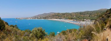 Marina di Camerota, Salerno, Campania, Italy - July 23, 2017: Panoramic photo of the Bay of Lentiscelle from the trail rising to the promontory dominated by Torre Zancale. clipart