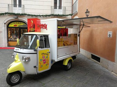 Benevento, Campania, Italy - December 21st 2017: Ape Piaggio set up for the Alberti witch in the internal courtyard of Palazzo Collenea clipart
