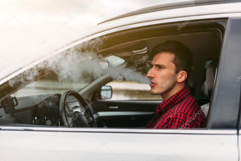 Man smoking while Driving a Car