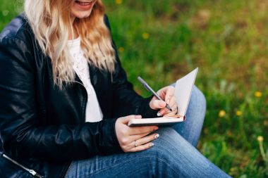 Kadın yazma not defterinde Şehir Parkı içinde