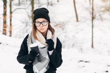 Kış parkta kızla kahve fincanı