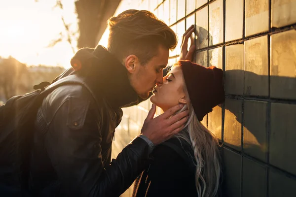 Young hipster couple kissing in city