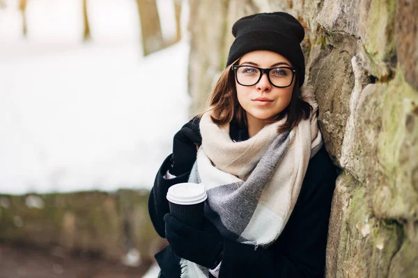 Menina no parque de inverno com xícara de café — Fotografia de Stock