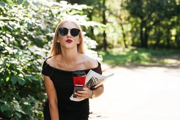 Donna in vestitino nero e occhiali da sole — Foto Stock