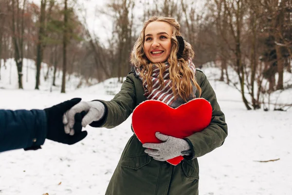 woman with heart-shaped pillow