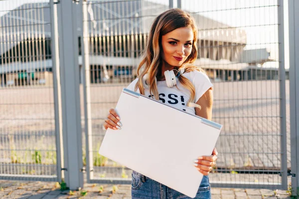 Mujer sosteniendo portátil fuera — Foto de Stock