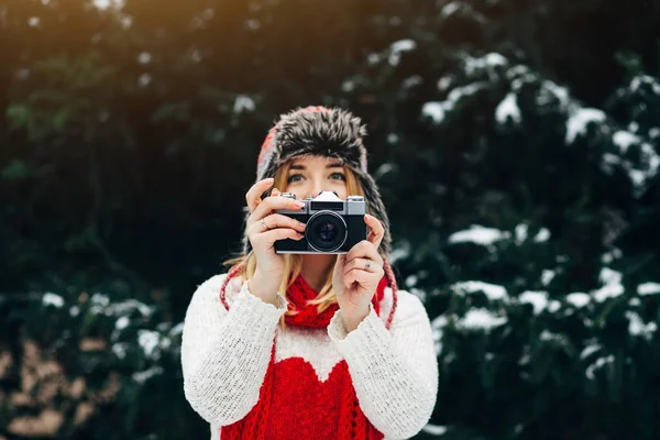 woman with analog camera in winter