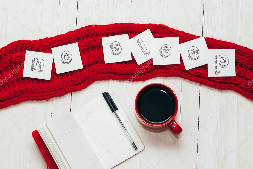 Coffee in red cup, notebook with pen and word 