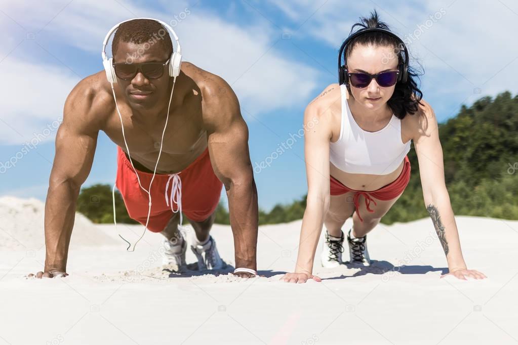 athletic couple doing push ups