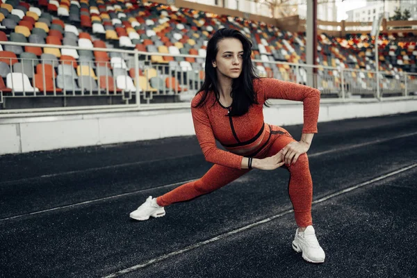 Portrait of One Sports Fitness Girl Dressed Fashion Sportswear Outfit Doing Stretches Exercise and Training at the City Stadium, Healthy Lifestyle Concept — ストック写真