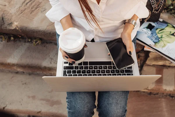 Retrato de uma menina na moda vestida em jeans e camisa branca segurando laptop, trabalhador freelance, senhora de negócios, conceito de poder da mulher — Fotografia de Stock