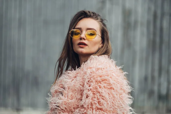 Close Up Portrait of One Stylish Girl in Pink Coat and Modern Yellow Sunglasses Posing on Street — Stock Photo, Image