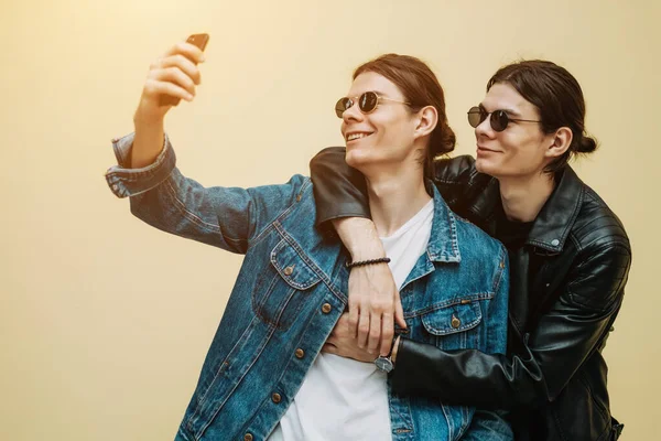 Fermer Portrait de deux frères jumeaux élégants utilisant un smartphone — Photo