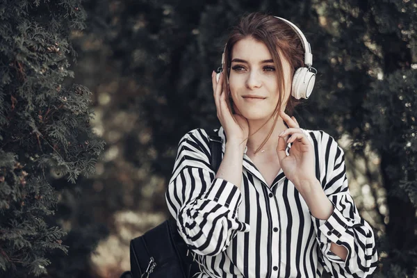 Outdoor Summer Portrait of Young Beautiful Girl in White Striped Stylish Dress Listens Music in Headphones — Stock Photo, Image