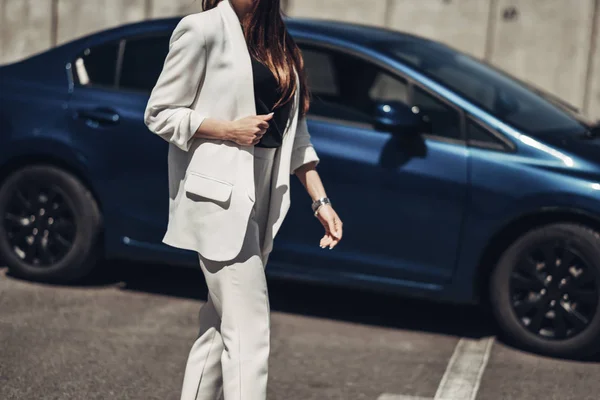 青い車の近くでポーズ白いスーツでファッションスタイリッシュな女の子 — ストック写真
