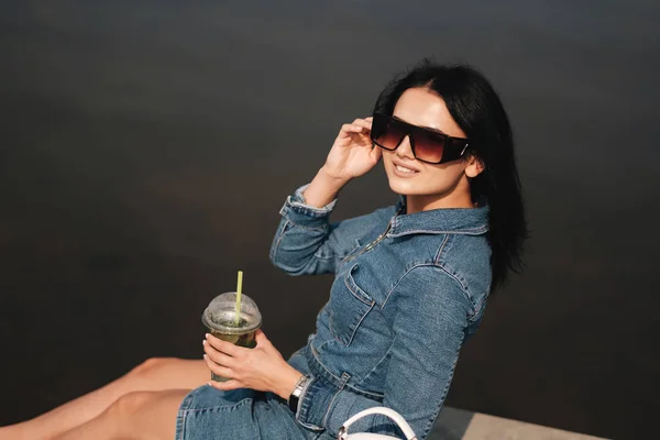 Portrait of One Beautiful Brunette Girl Dressed in Jeans Denim Overalls Spends Leisure Time — Stockfoto