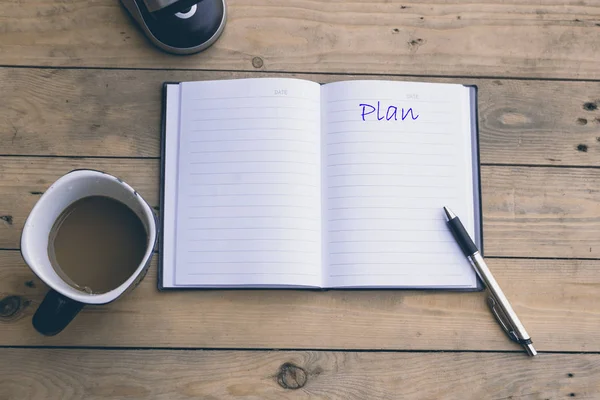 Open notebook with coffee cup — Stock Photo, Image