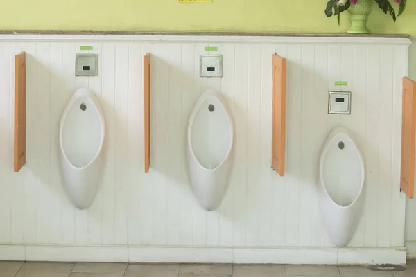 Closeup of three white urinals — Stock Photo, Image