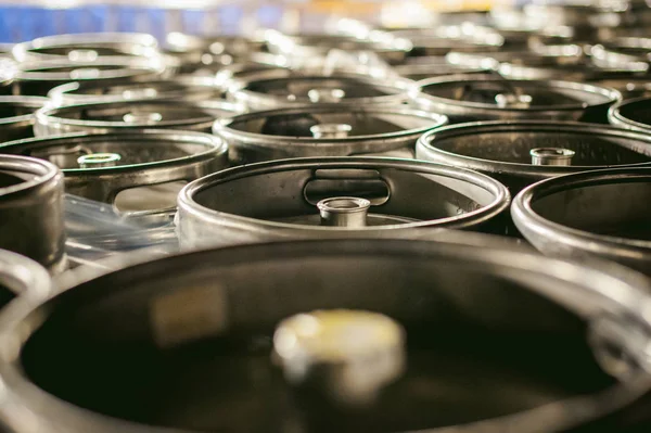 beer kegs. many metal beer keg stand in rows in a warehouse