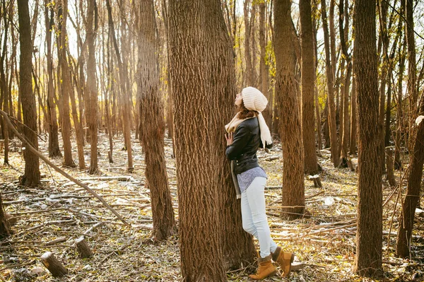 Молодая женщина ходит среди деревьев на берегу солнечного дня — стоковое фото