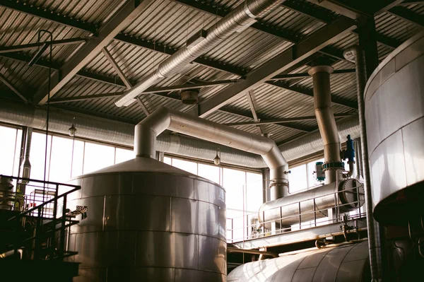 Beer manufacture line. Equipment for staged production bottling of Finished food products. Metal structures, pipes and tanks at enterprise factory. Special equipment inside within industrial premises — Stock Photo, Image