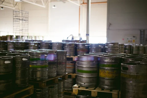 beer kegs. many metal beer keg stand in rows in a warehouse