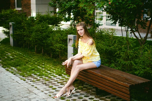 Mladá krásná žena, je procházka venku na dvoře, na pozadí zelení a domy, teplé letní slunečný den — Stock fotografie