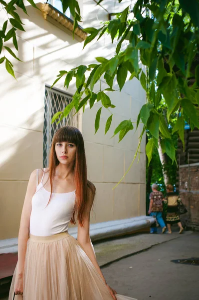 Caddenin bir sıcak güneşli yaz günü yürüyen genç güzel kadın