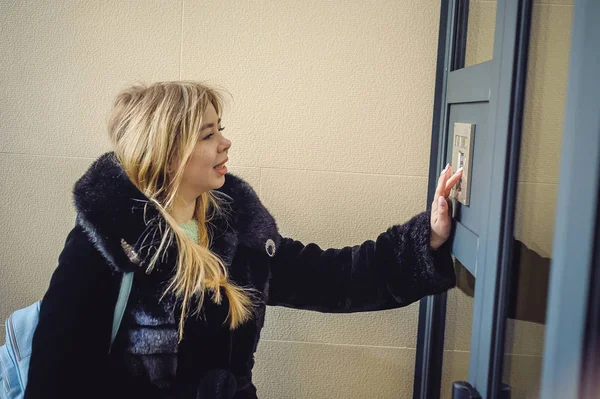 Young Blond Woman Fur Coat Dials Code Doorphone Panel Presses — Stock Photo, Image