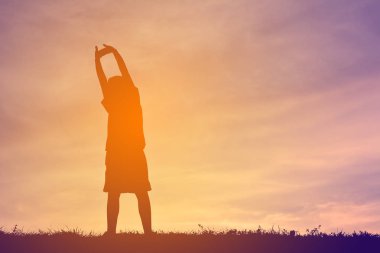 Siluet bir çocuk sakin ol günbatımı üzerinde