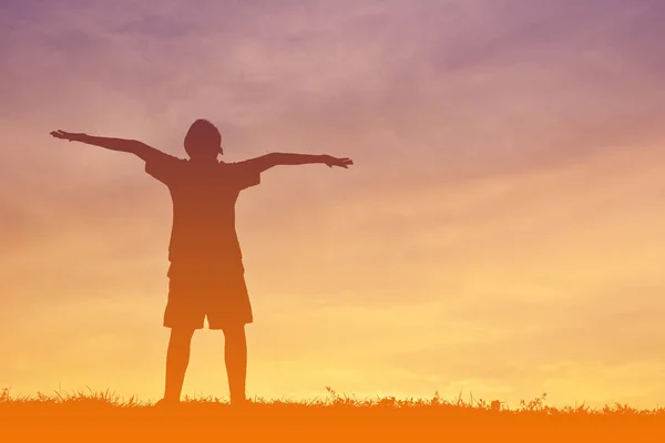 Silhouette a boy relax on sunset — Stock Photo, Image