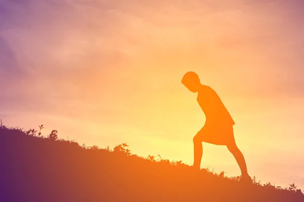 Silhouette a boy running on sunset — Stock Photo, Image