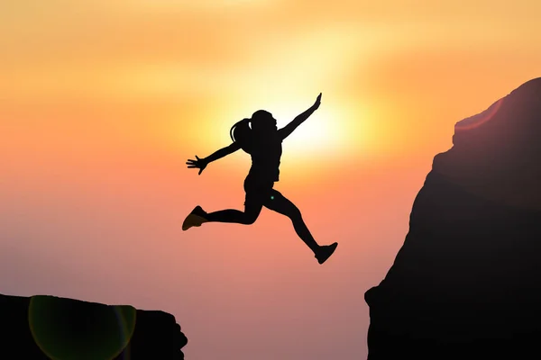 Silhouette women jumping — Stock Photo, Image