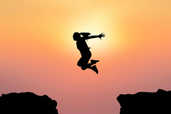 Silhouette women jumping on sunset — Stock Photo, Image